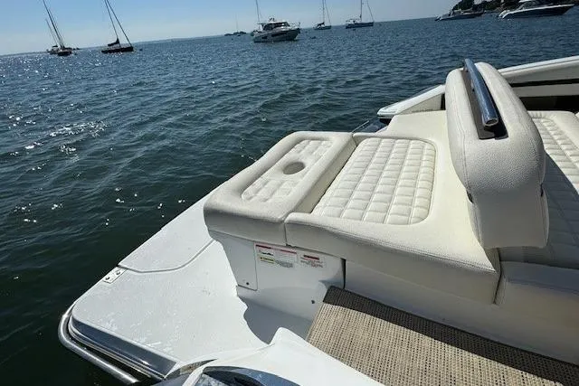 Slide: The Image of 2019 Cobalt R7 boat with white seating, on a sunny day, surrounded by water and other boats. - 5