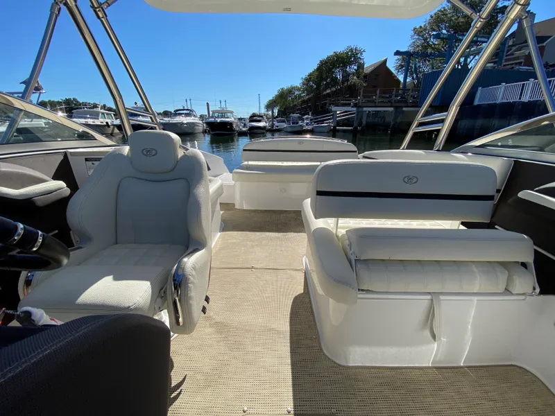Slide: The Image of 2019 Cobalt R7 boat interior with plush seating, docked at a marina. - 8