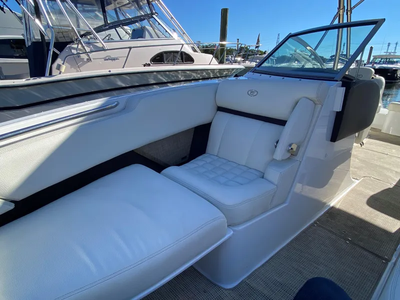 Slide: The Image of 2019 Cobalt R7 boat interior with white leather seating, docked at marina. - 9