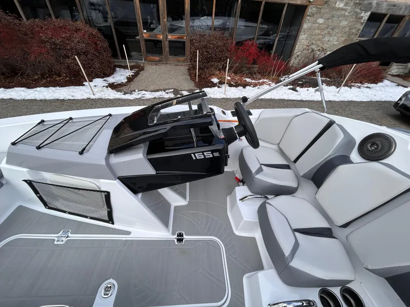 Slide: The Image of 2025 Scarab 165 SE boat interior with sleek gray seating and modern design. - 16