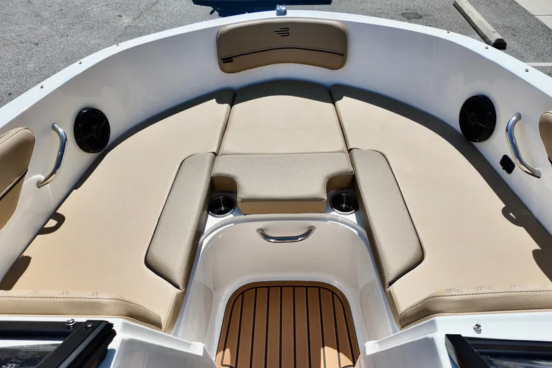 Slide: The Image of 2025 Bayliner VR4 Bowrider OB interior with beige seating and cup holders. - 14