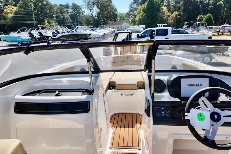Slide: The Image of 2025 Bayliner VR4 Bowrider OB interior with Simrad display, steering wheel, and seating. - 8