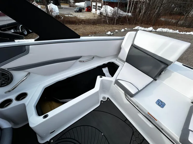 Slide: The Image of 2024 Scarab 215 Wake LE boat interior with open storage compartment. - 13