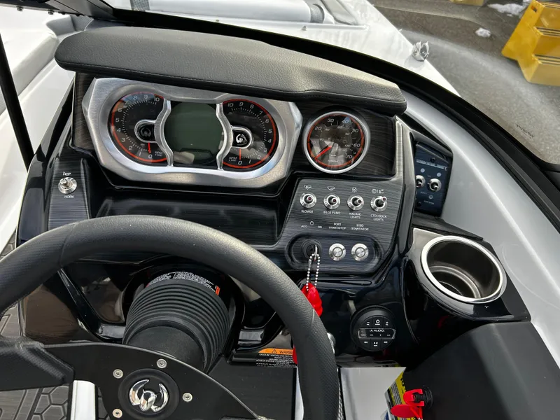 Slide: The Image of Dashboard of 2024 Scarab 215 Wake LE boat with steering wheel and control panel. - 19