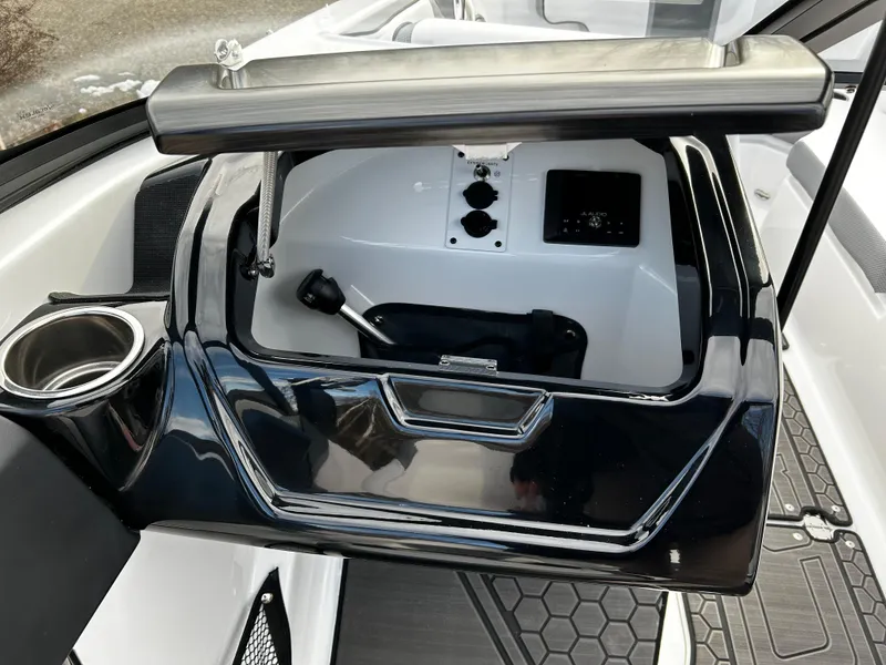 Slide: The Image of 2024 Scarab 215 Wake LE boat interior storage compartment with cup holder. - 22