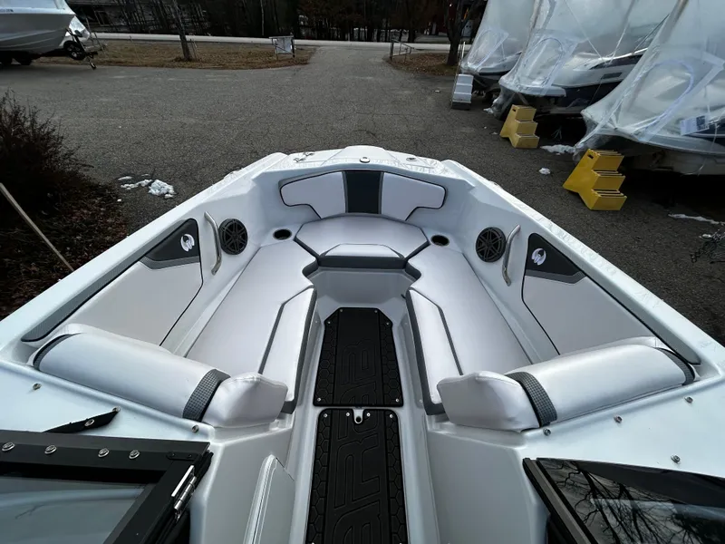 Slide: The Image of 2024 Scarab 215 Wake LE boat interior with white and gray seating. - 23
