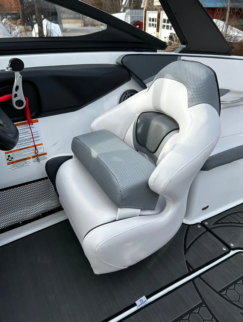 Slide: The Image of 2024 Scarab 215 Wake LE boat interior with a white and gray captain's seat. - 45
