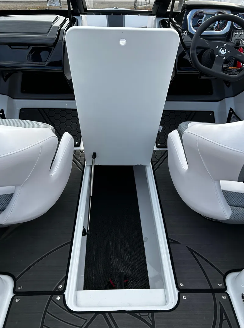 Slide: The Image of 2024 Scarab 215 Wake LE boat interior with open storage compartment. - 48