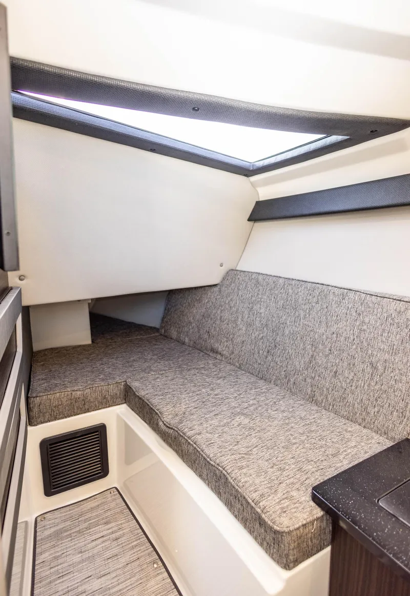 Slide: The Image of 2023 Cobalt R33 cabin interior with cushioned seating and skylight. - 27