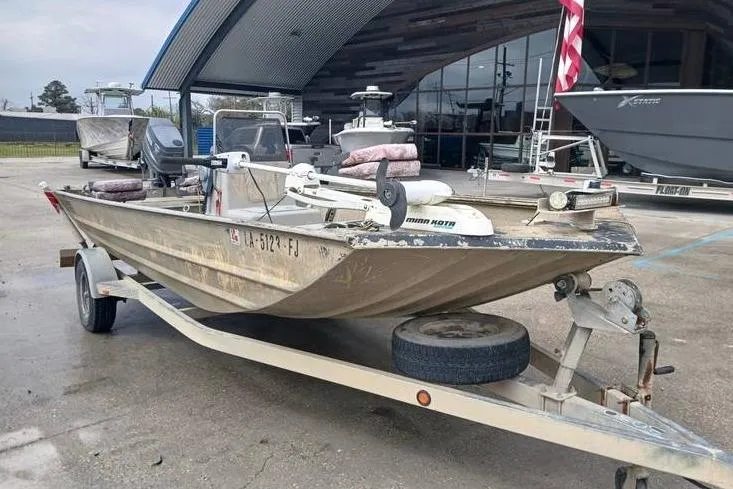 Slide: The Image of 2004 Xpress XP18CC boat on trailer, parked outdoors near a modern building. - 5