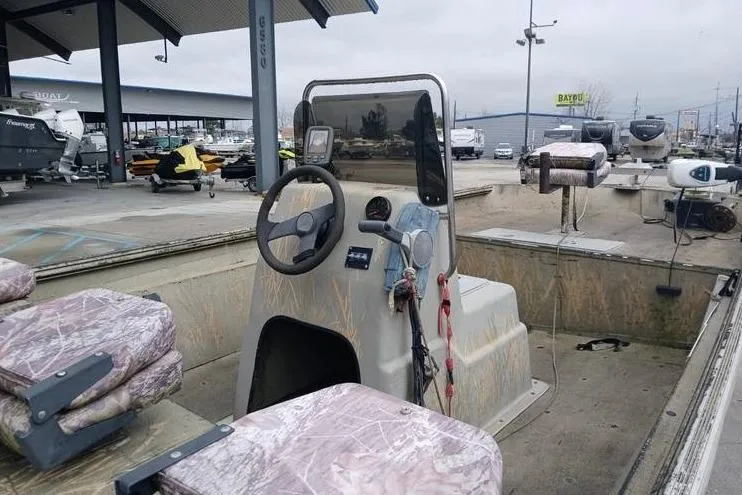 Slide: The Image of 2004 Xpress XP18CC boat with camouflage seats at a dealership. - 8