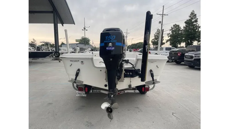 Slide: The Image of 2005 Sea Fox 205 Bay Fisher boat with outboard motor, parked outdoors. - 11
