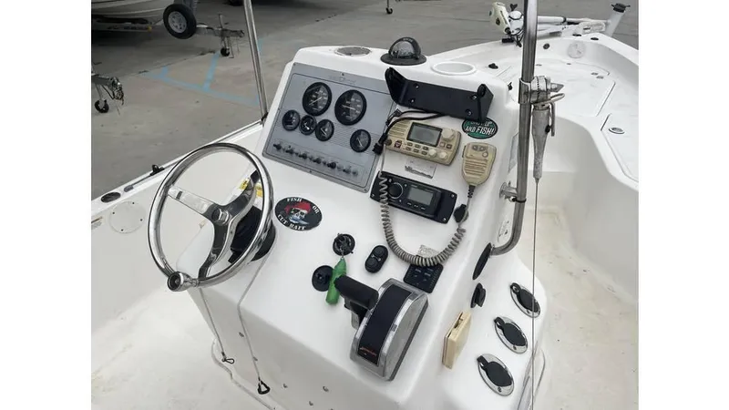 Slide: The Image of 2005 Sea Fox 205 Bay Fisher boat dashboard with steering wheel and navigation controls. - 3
