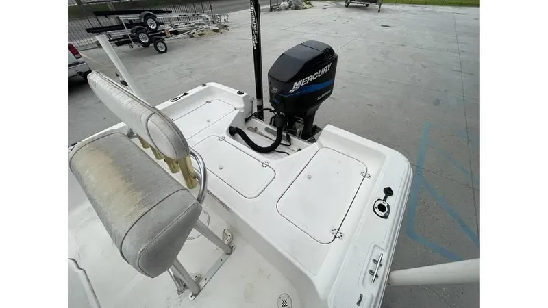 Slide: The Image of 2005 Sea Fox 205 Bay Fisher boat with Mercury outboard motor, featuring cushioned seating. - 4
