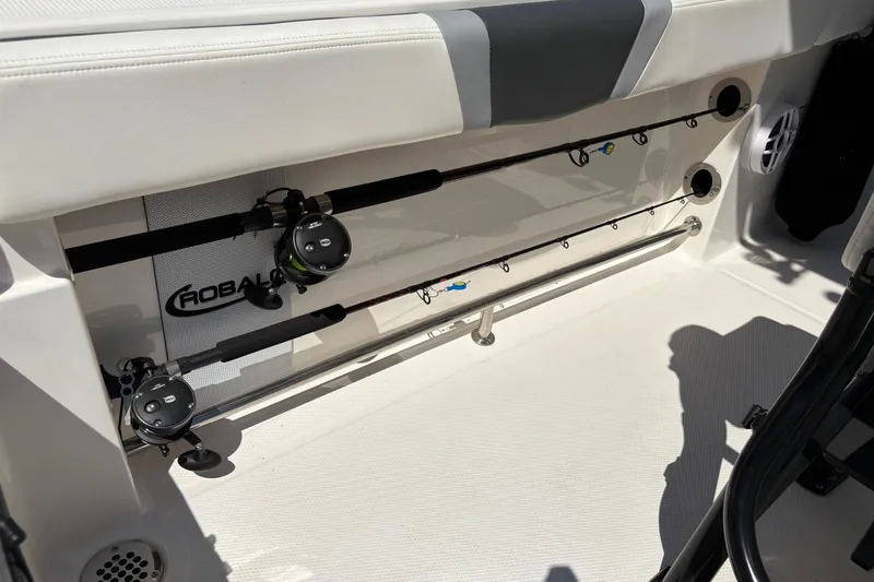 Slide: The Image of 2022 Robalo R230 Center Console boat with outboard motor, docked in sunlight. - 12