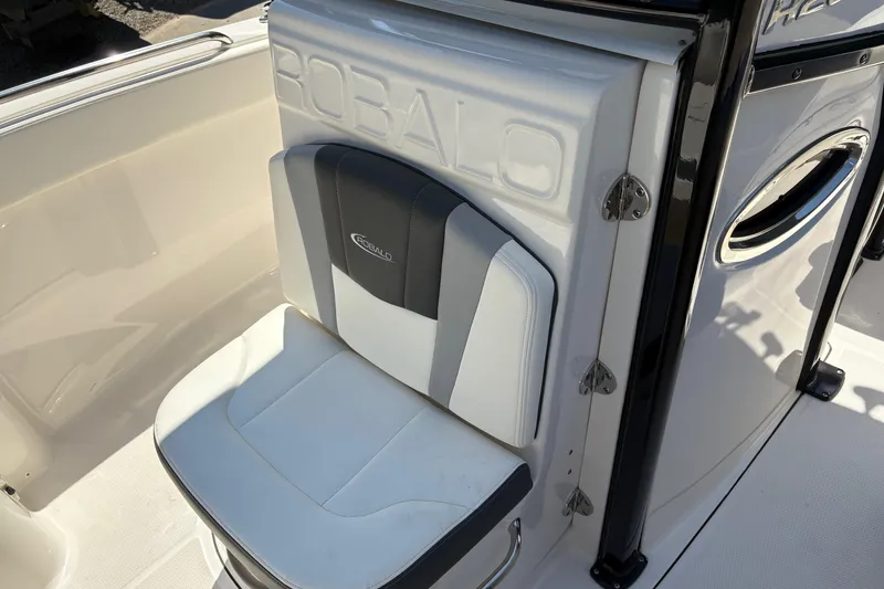 Slide: The Image of 2022 Robalo R230 Center Console fishing rod storage area with mounted rods. - 13
