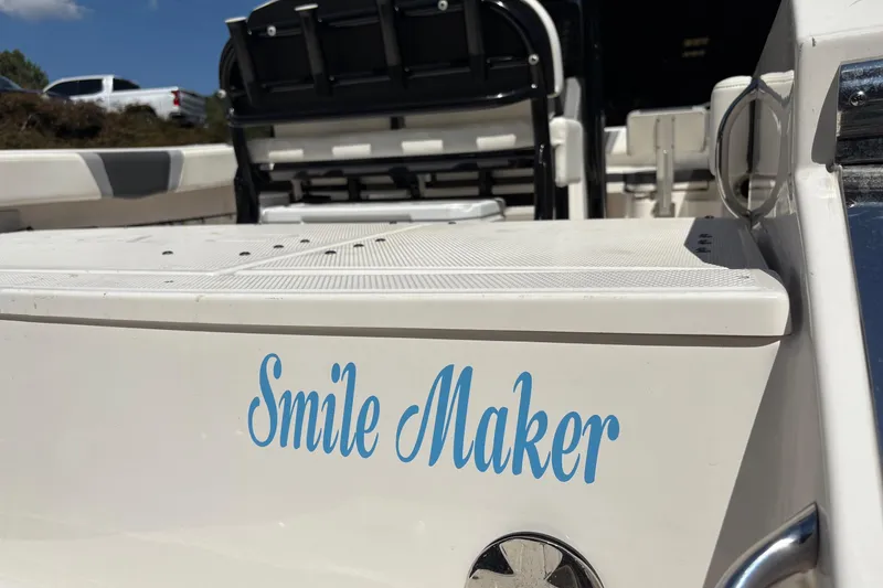 Slide: The Image of 2022 Robalo R230 Center Console boat interior with compact marine toilet. - 15