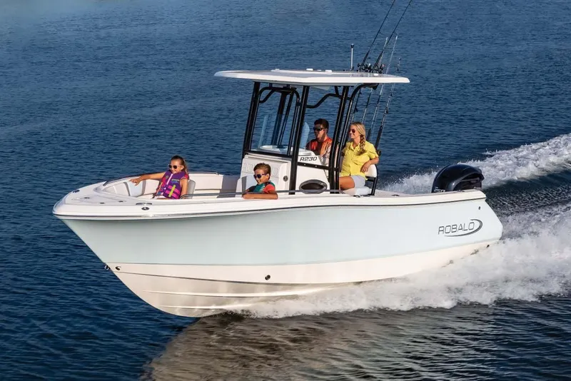 Slide: The Image of Manufacturer Provided Image: 2022 Robalo R230 Center Console boat cruising on a lake with passengers. - 18