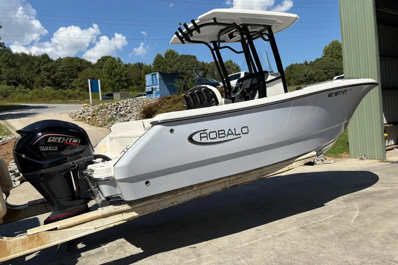 Slide: The Image of 2022 Robalo R230 Center Console boat on trailer, side view, outdoors. - 2