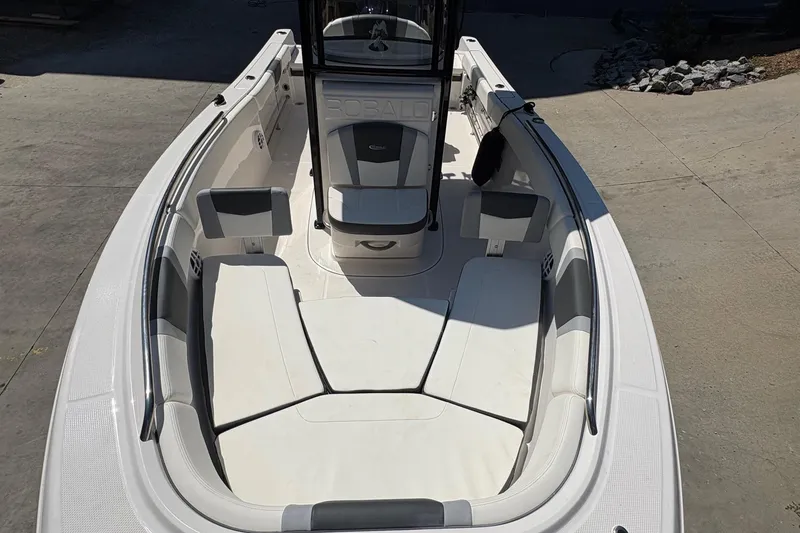 Slide: The Image of 2022 Robalo R230 Center Console boat interior with cushioned seating and storage. - 6