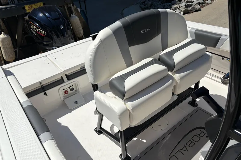 Slide: The Image of 2022 Robalo R230 Center Console boat interior with Garmin display and Coleman cooler. - 8