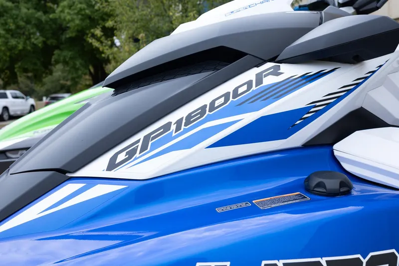 Slide: The Image of 2023 Kawasaki Jetski Ultra 310LX-S, blue and white design, parked outdoors. - 21