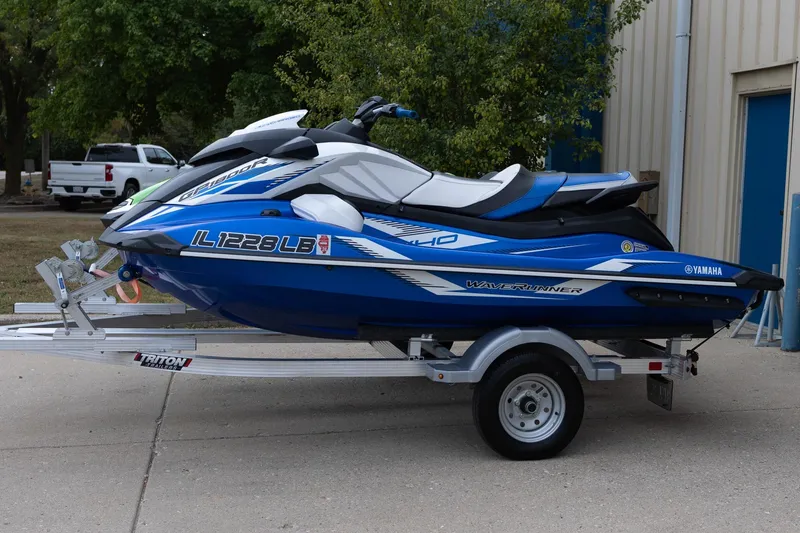 Slide: The Image of 2023 Kawasaki Jetski Ultra 310LX-S on trailer, blue and white design, parked outdoors. - 3