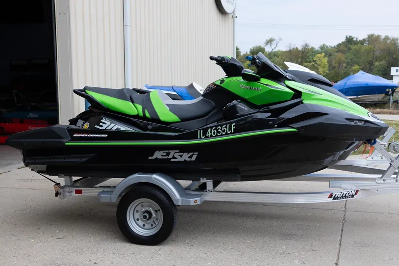 Slide: The Image of 2023 Kawasaki Jetski Ultra 310LX-S on trailer, green and black design. - 7