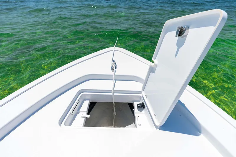 Slide: The Image of Manufacturer Provided Image: 2025 Sportsman Masters 247 Bay Boat with open storage hatch on clear water. - 10
