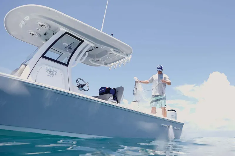 Slide: The Image of Manufacturer Provided Image: 2025 Sportsman Masters 247 Bay Boat on water, man fishing under clear sky. - 7