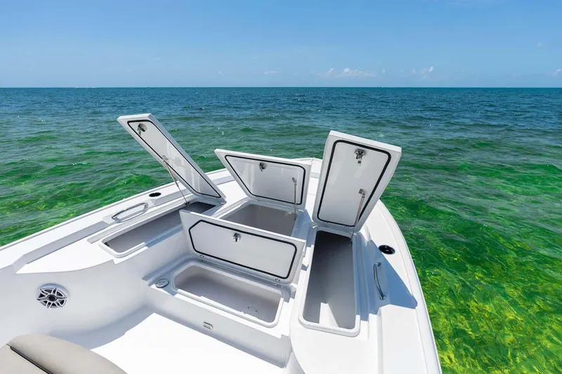 Slide: The Image of Manufacturer Provided Image: 2025 Sportsman Masters 247 Bay Boat with open storage compartments on clear ocean water. - 11