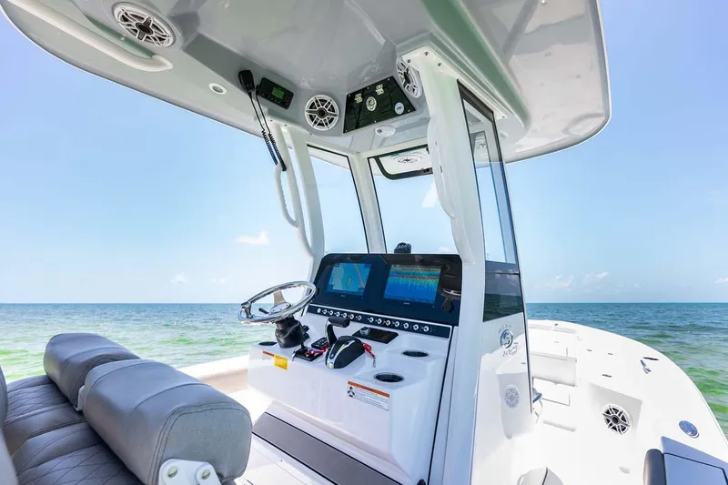 Slide: The Image of Manufacturer Provided Image: 2025 Sportsman Masters 247 Bay Boat interior with modern dashboard and ocean view. - 15