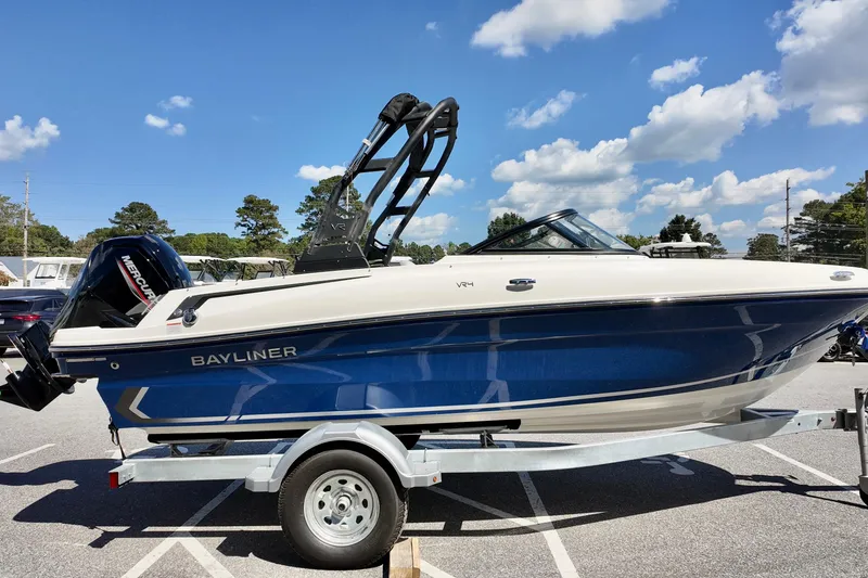 Slide: The Image of 2025 Bayliner VR4 Bowrider OB boat on trailer under blue sky. - 3