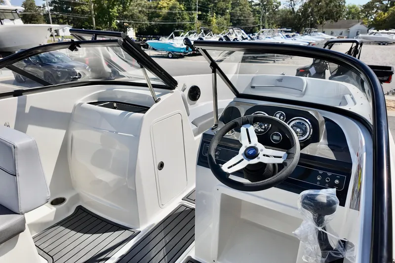 Slide: The Image of 2025 Bayliner VR4 Bowrider OB interior with steering wheel and dashboard controls. - 5