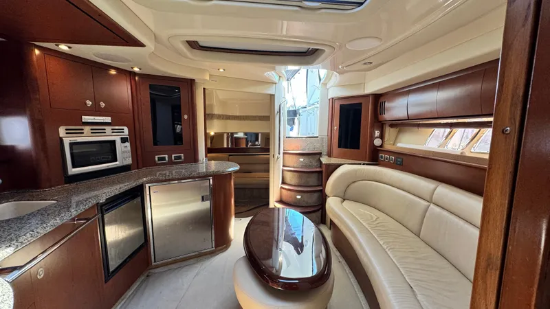 Slide: The Image of Luxurious interior of a 2007 Sea Ray 44 Sundancer yacht with modern kitchen and seating area. - 10