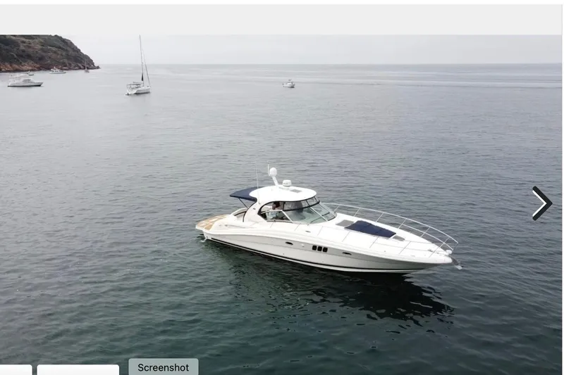 Slide: The Image of 2007 Sea Ray 44 Sundancer yacht cruising on calm ocean waters. - 17