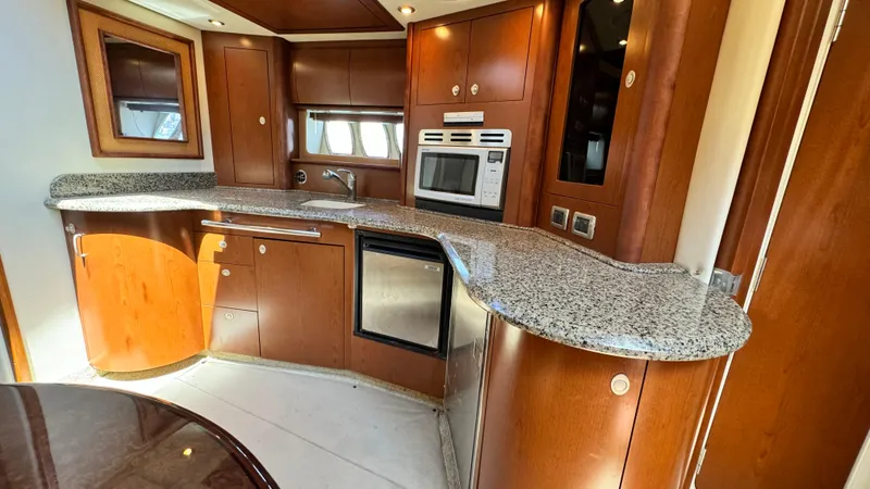 Slide: The Image of Luxurious 2007 Sea Ray 44 Sundancer yacht kitchen with granite countertops and modern appliances. - 7
