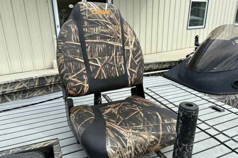 Slide: The Image of Camouflage seat on 2016 Lowe Stinger 175C boat, docked near a building. - 10