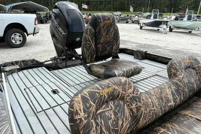 Slide: The Image of 2016 Lowe Stinger 175C boat with camo seats and Mercury outboard motor. - 12