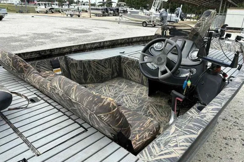Slide: The Image of 2016 Lowe Stinger 175C boat interior with camo seats and steering console. - 15
