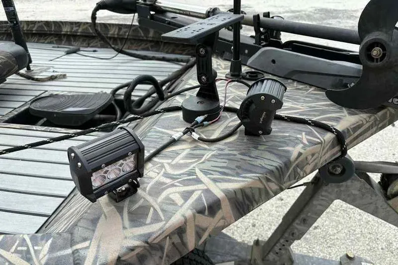 Slide: The Image of 2016 Lowe Stinger 175C boat with mounted LED lights and camouflage design. - 3