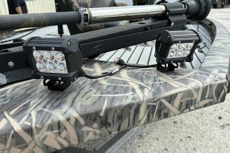 Slide: The Image of 2016 Lowe Stinger 175C boat with mounted LED lights and camouflage pattern. - 4