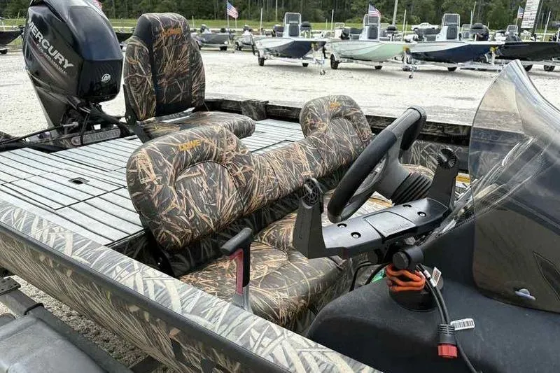 Slide: The Image of 2016 Lowe Stinger 175C boat with camo seats and Mercury outboard motor. - 9
