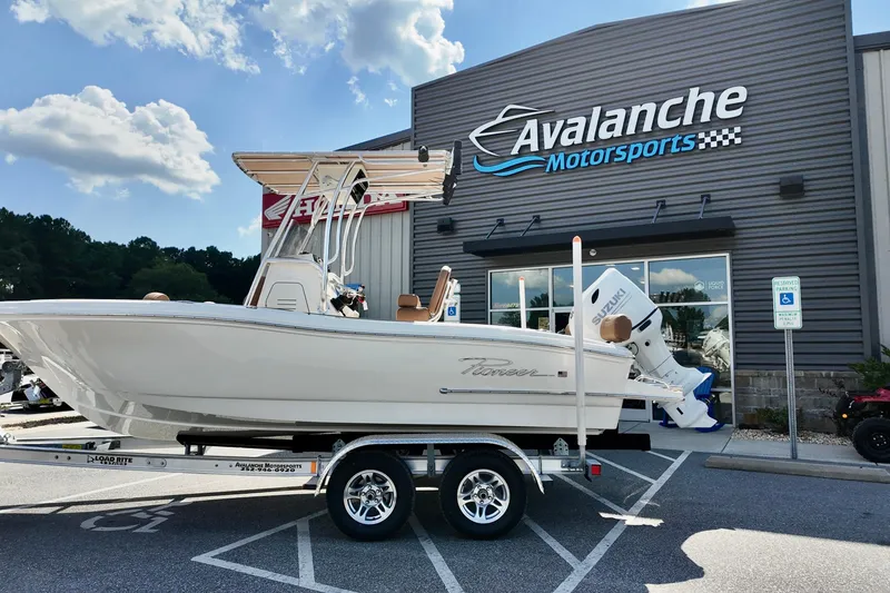 The Image of 2026 Pioneer 202 Sportfish boat on trailer at Avalanche Motorsports dealership. - 1