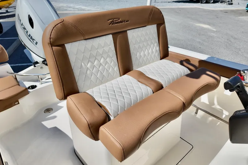 Slide: The Image of 2026 Pioneer 202 Sportfish boat seat with tan and white diamond stitching. - 10
