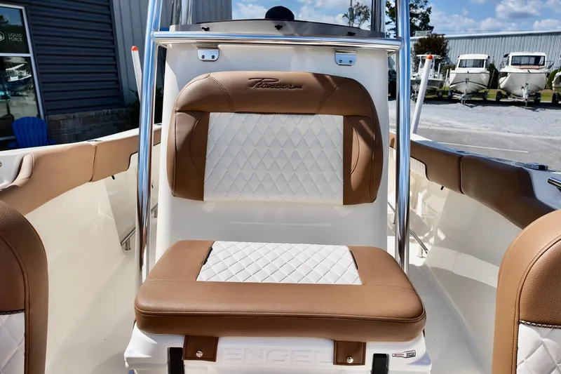 Slide: The Image of 2026 Pioneer 202 Sportfish boat interior with brown and white cushioned seating. - 11