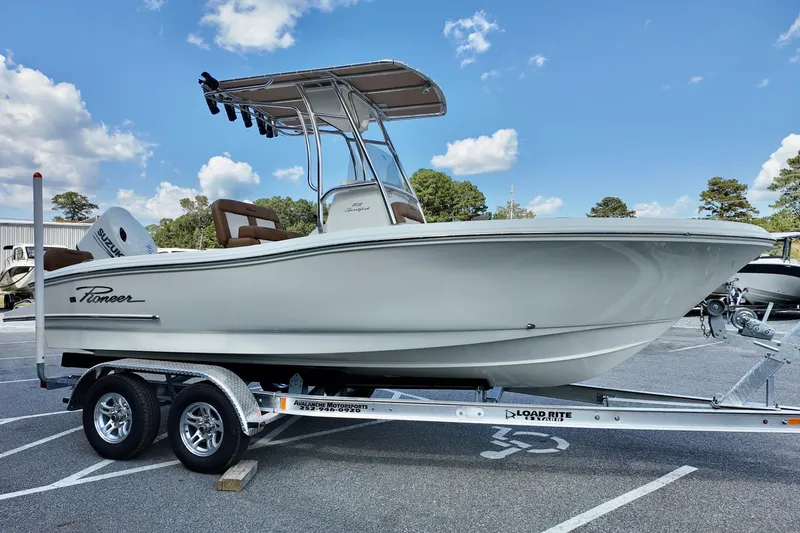Slide: The Image of 2026 Pioneer 202 Sportfish boat on trailer under clear blue sky. - 3
