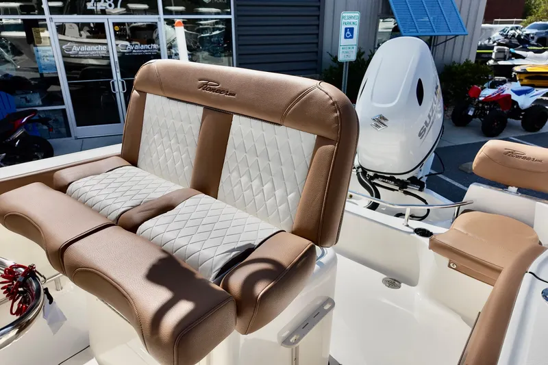 Slide: The Image of 2026 Pioneer 202 Sportfish boat interior with tan and white seating, Suzuki outboard motor. - 5