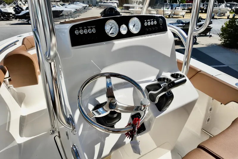 Slide: The Image of 2026 Pioneer 202 Sportfish boat dashboard with steering wheel and controls. - 7