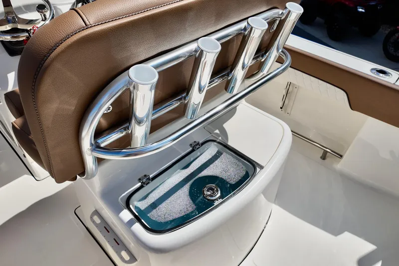 Slide: The Image of 2026 Pioneer 202 Sportfish boat interior with rod holders and livewell. - 8